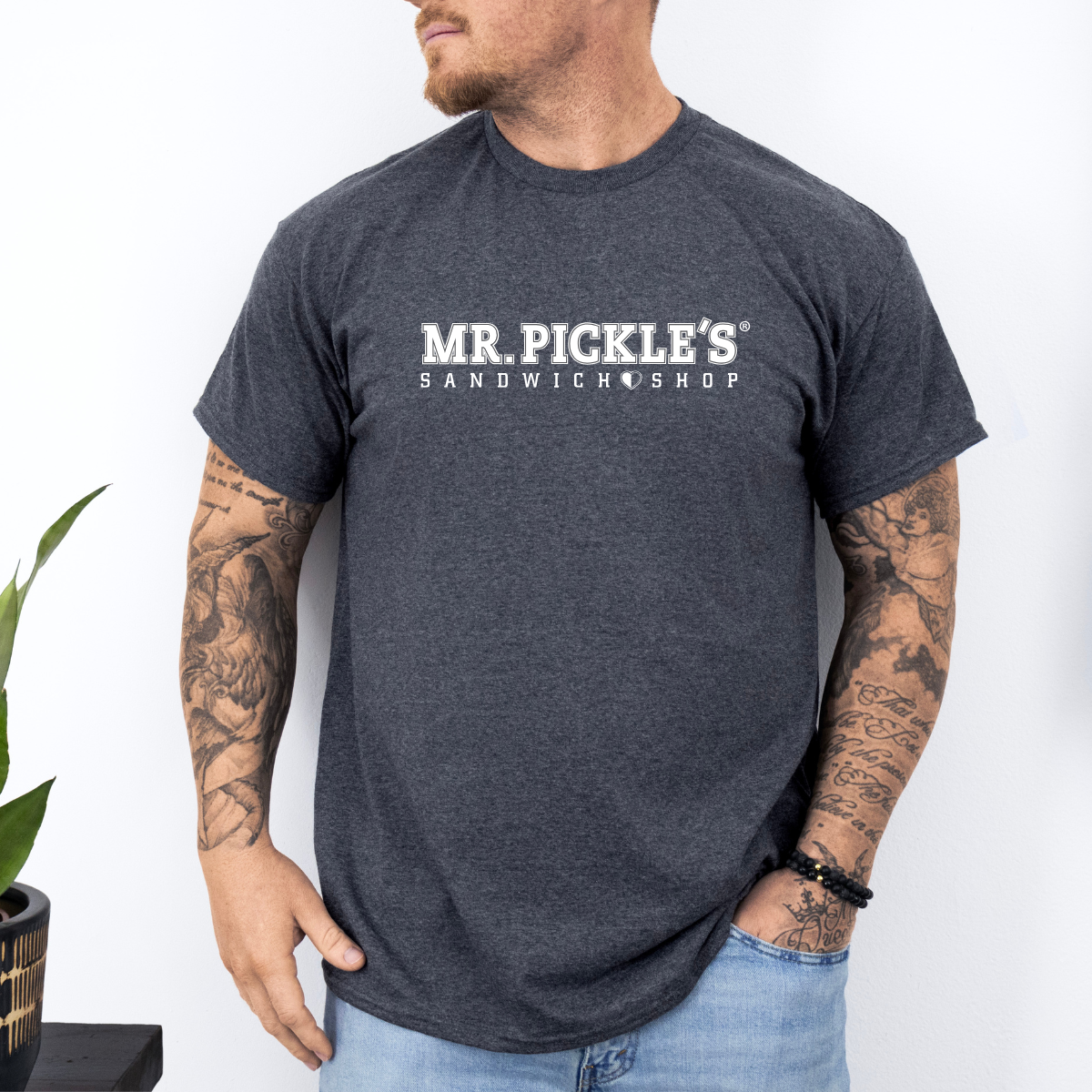 Person wearing a dark gray t-shirt with 'MR. PICKLE'S SANDWICH SHOP' text on a white background