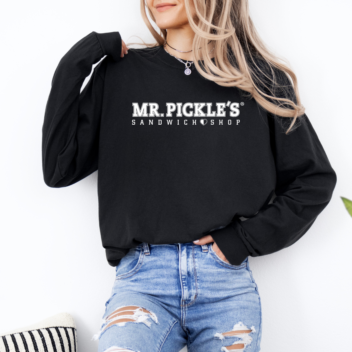 Person wearing a black sweatshirt with 'MR. PICKLE'S SANDWICH SHOP' text on a white background