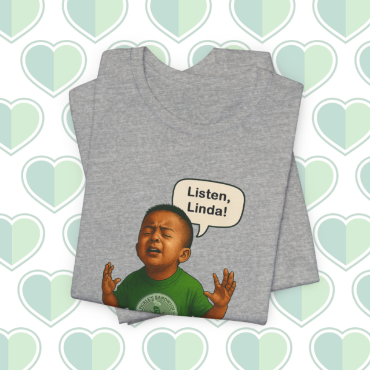 Gray t-shirt with a graphic of a child and 'Listen, Linda!' text on a heart-patterned background