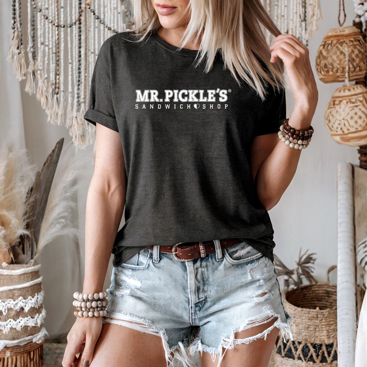 Person wearing a black t-shirt with 'MR. PICKLE'S SANDWICH SHOP' text in a casual setting.