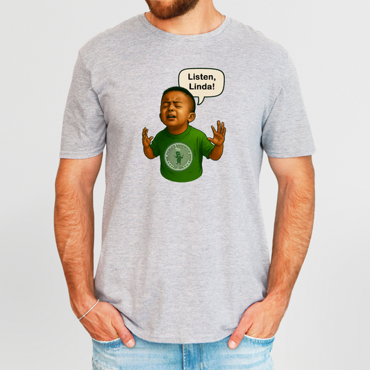 Gray t-shirt with a graphic of a child in a green shirt and a speech bubble saying 'Listen, Linda!' on a plain background.
