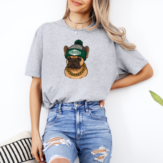 Person wearing a gray t-shirt with a graphic of a dog wearing a green cap and gold chain.