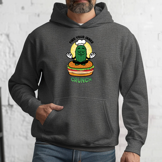 Person wearing a dark gray hoodie with a graphic design on a white brick wall background