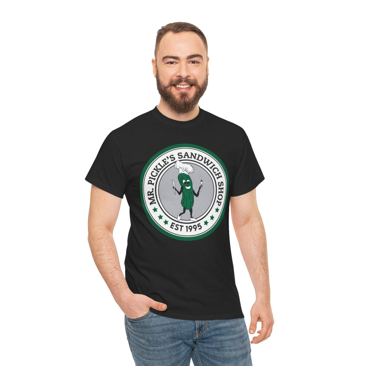 Man wearing a black t-shirt with a green and white logo on a white background