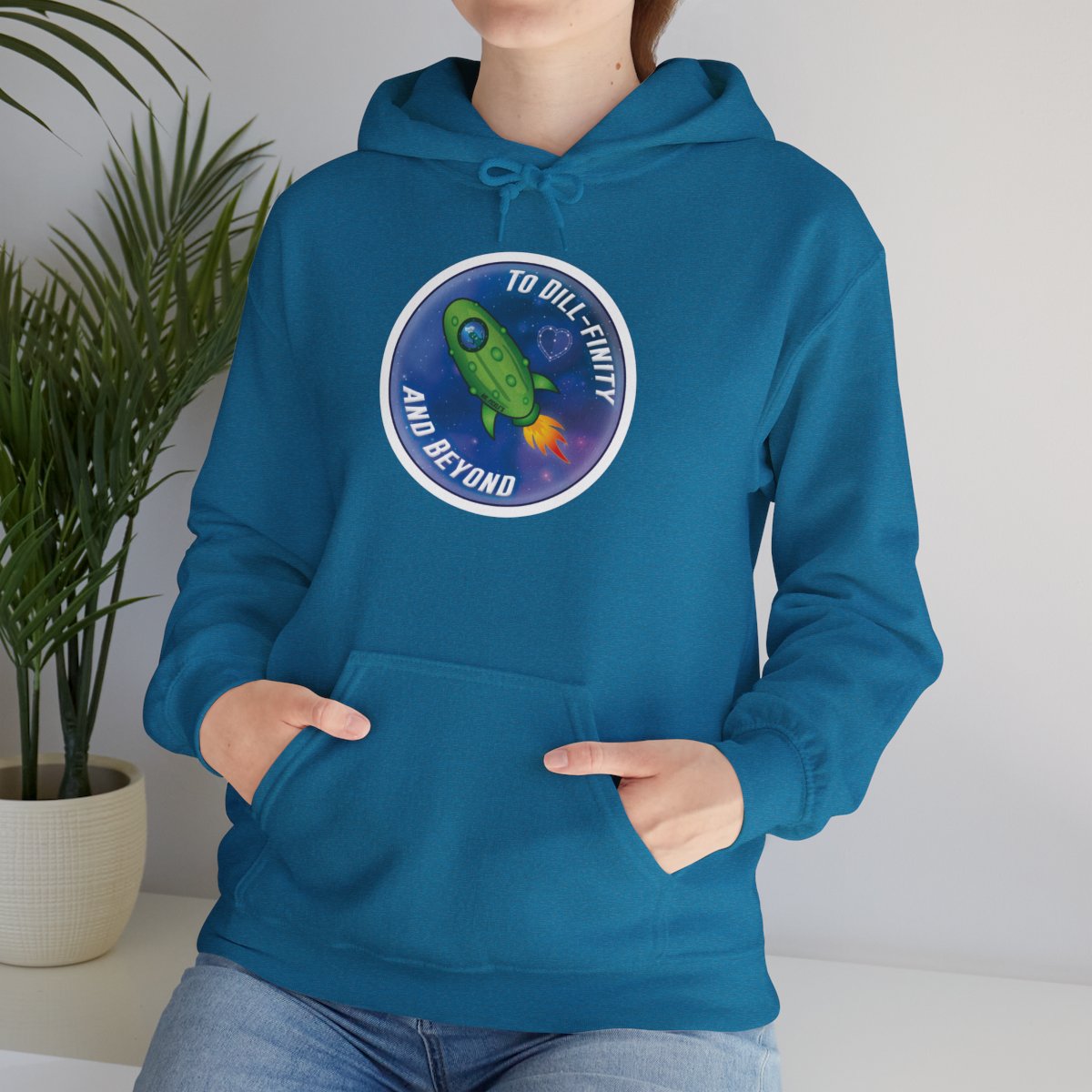 Person wearing a blue hoodie with a graphic design on a plain background