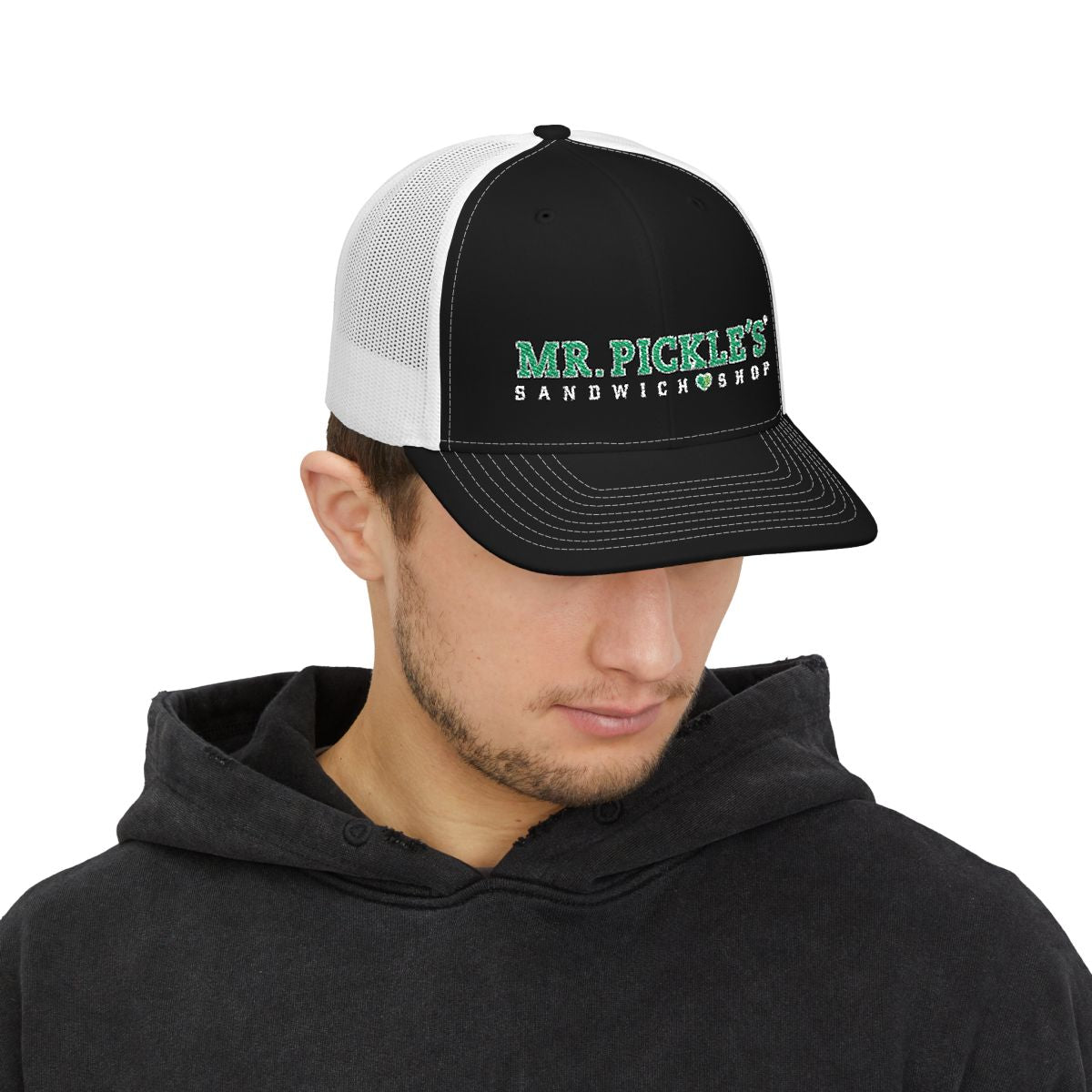 Man wearing a black and white cap with 'Mr. Pickle's Sandwich Shop' logo on a white background